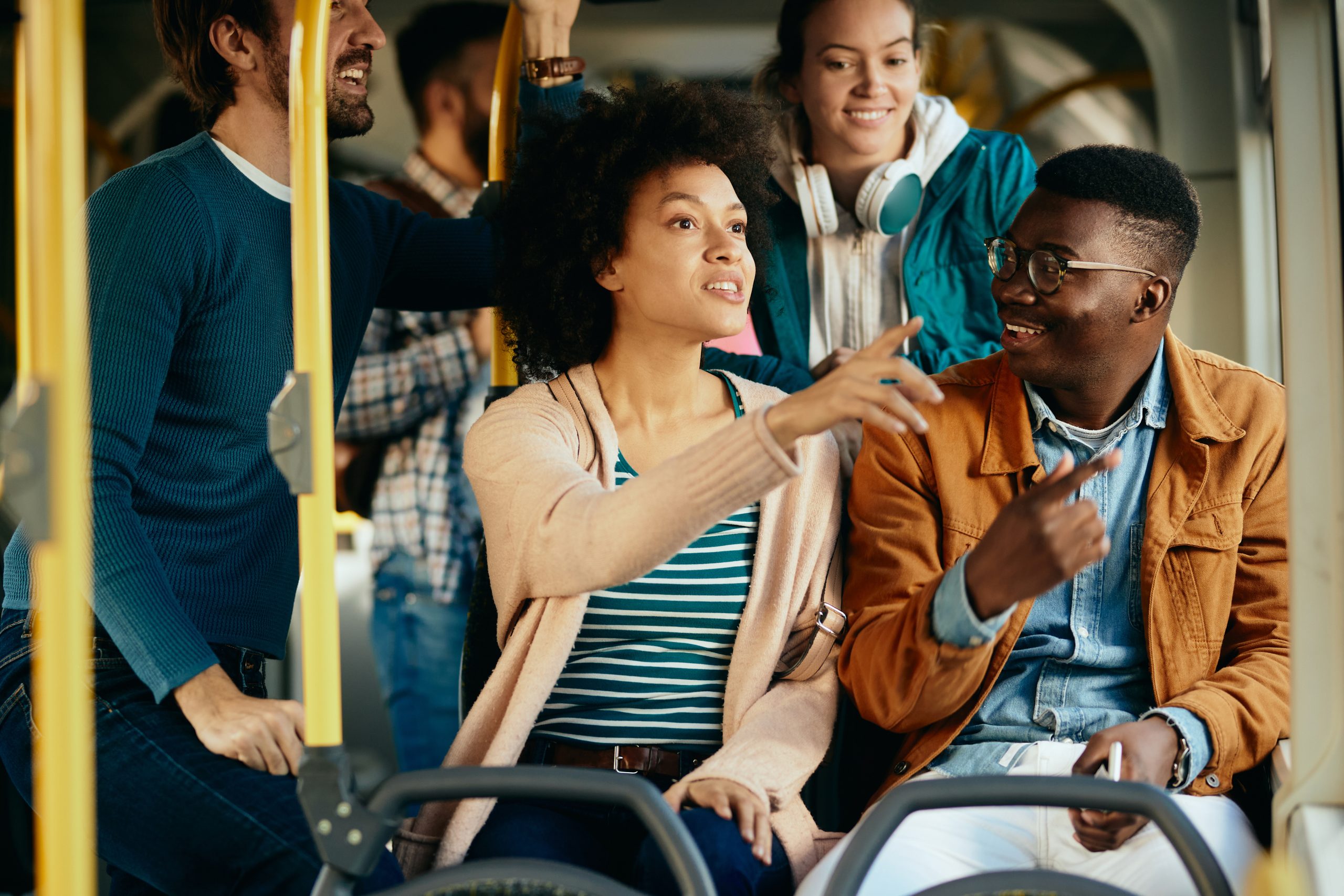 happy black couple talking and pointing through the window while